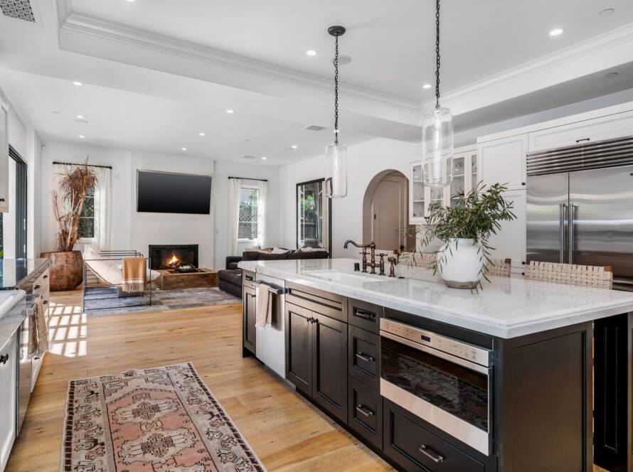 a white kitchen with lots of cabinets and counter tops on it
